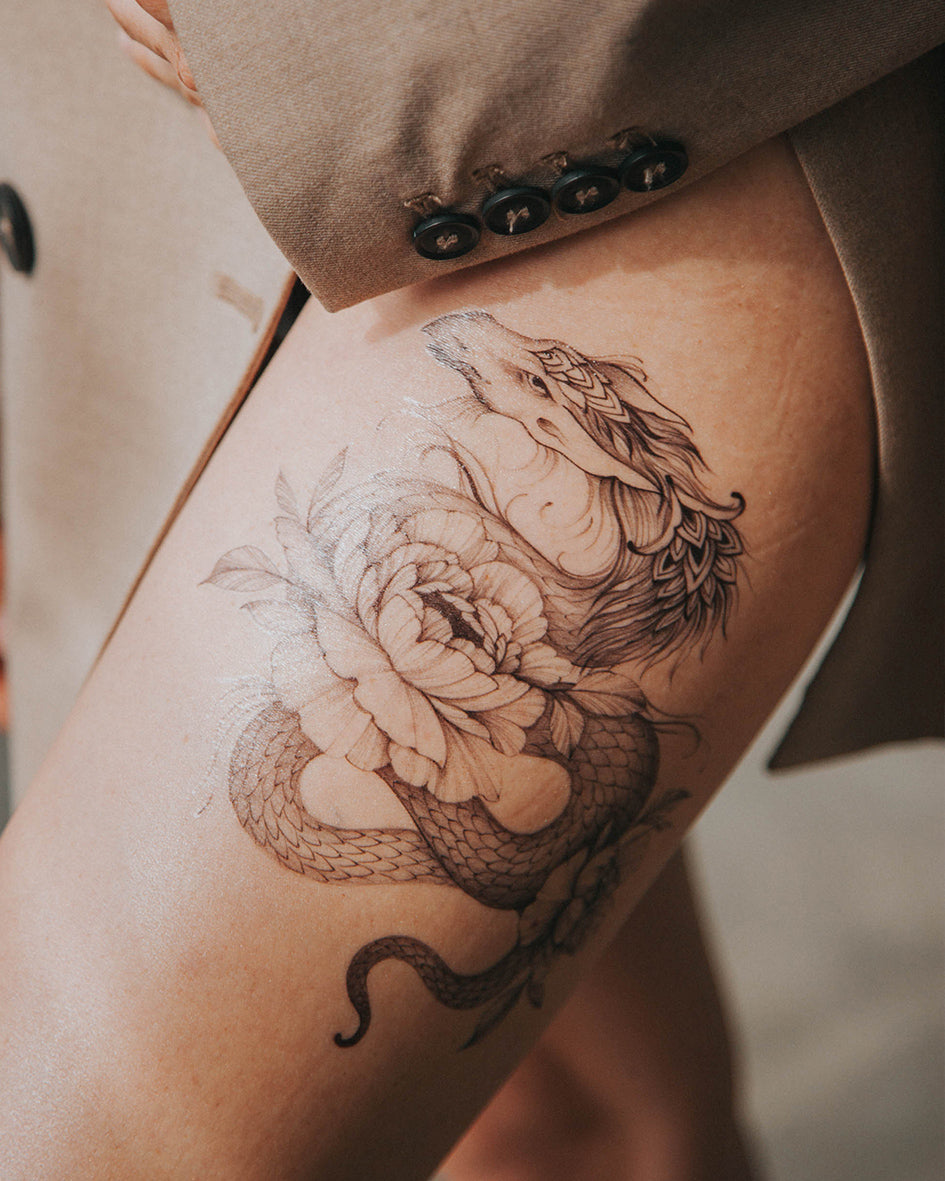 Dragon Thigh Tattoo with Blooming Flowers